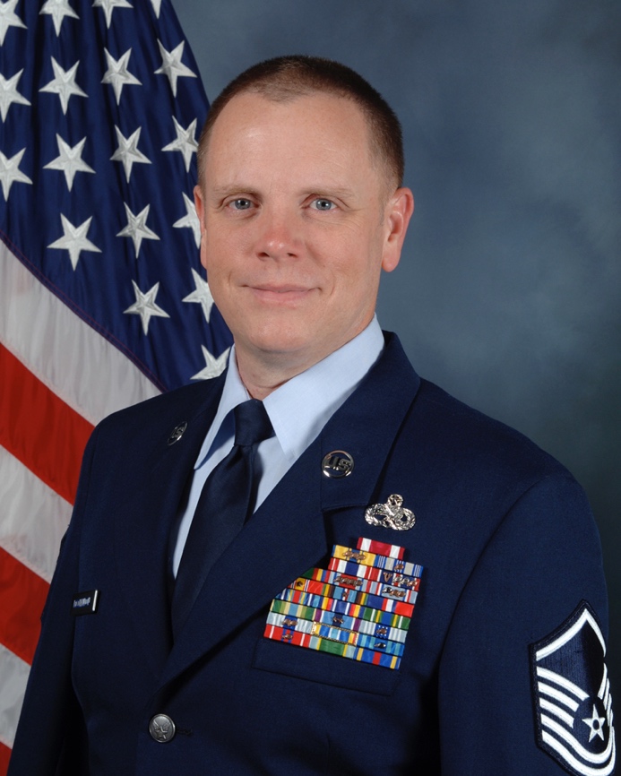 A picture containing person, clothing, person, suit  Description automatically generated