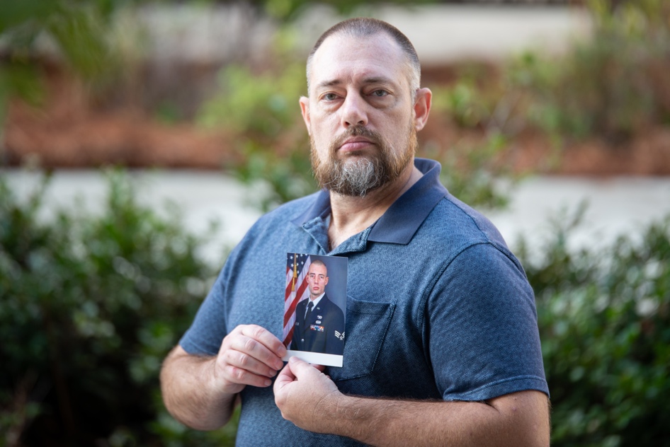 A person holding a card  Description automatically generated with low confidence