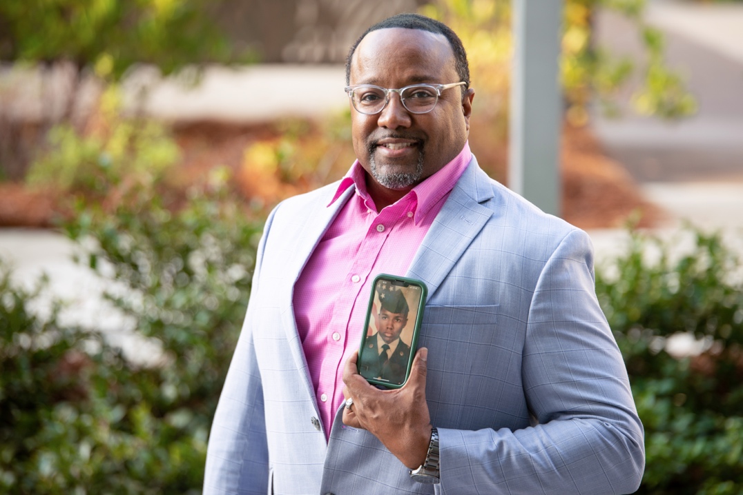 A person holding a picture  Description automatically generated with low confidence