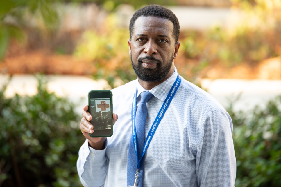 A person holding a phone  Description automatically generated with low confidence