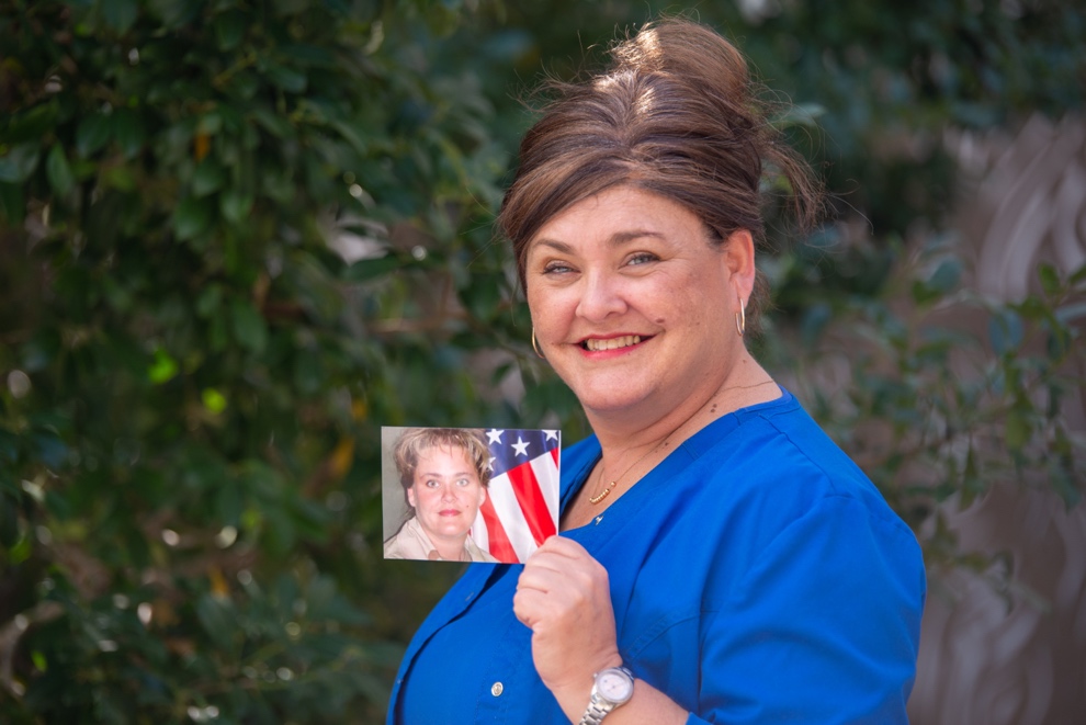 A person holding a picture  Description automatically generated with medium confidence