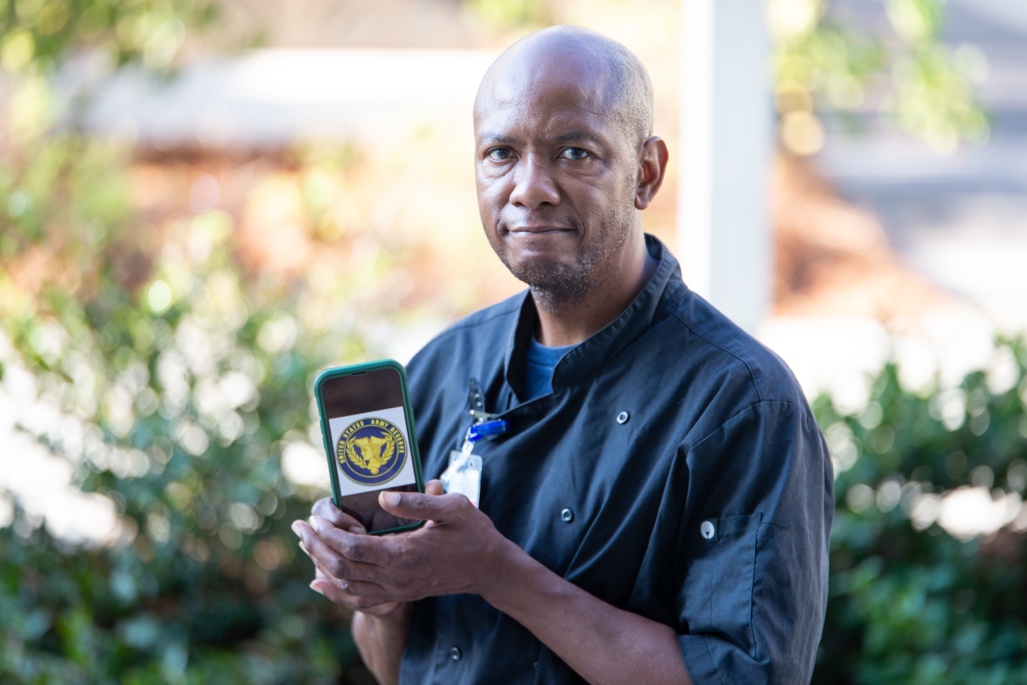 A person holding a card  Description automatically generated with low confidence