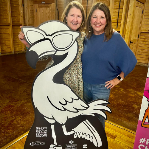 Board members pose with Flamingo Challenge poster