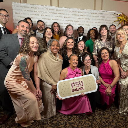 Lakesha Drew and group of TMH colleagues pose at an event